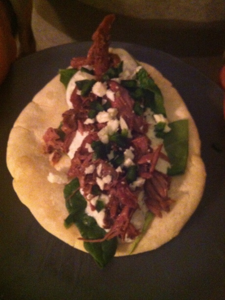 Assembled - lamb, spinach, cucumber sauce, feta cheese and diced green peppers.